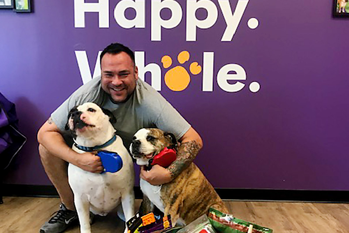 Happy dogs and client at central bark